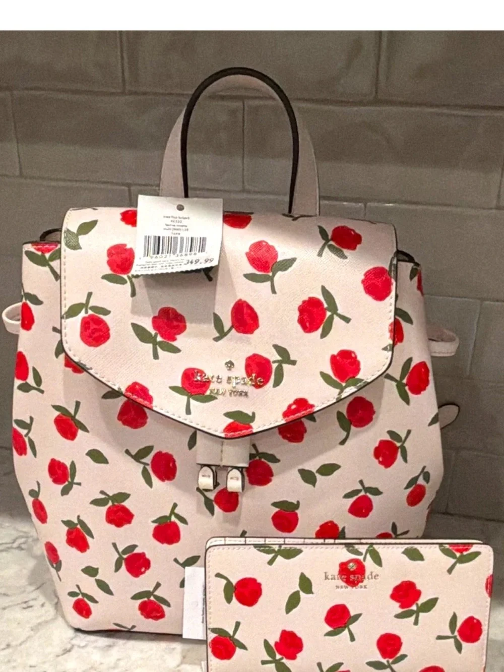kate spade cream backpack with red floral print